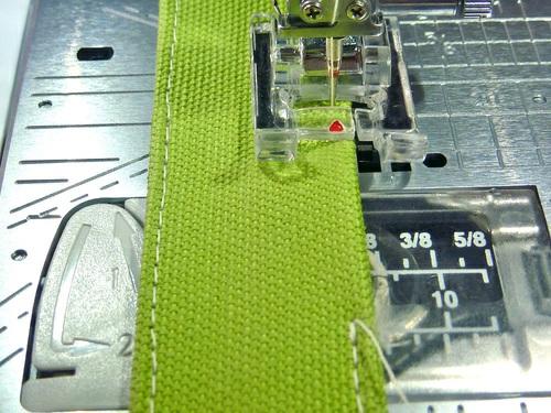 7. Place the loop on the apron front. It should be positioned 3½" down from the bottom of the armhole curve and 5½" in from the left side of the apron panel. Pin the loop in place at both ends.