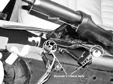 Using your socket and ratchet, remove the two 10mm nuts that secure the emergency brake boot wire form to the console, (Illus. L). ILLUS. L STEP 13.