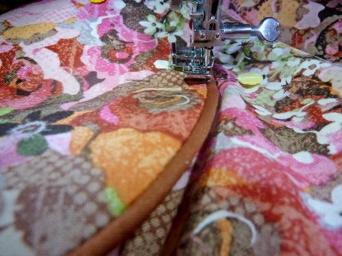 Use a Zipper foot to stitch each pocket in place, running your seam right along the piping.