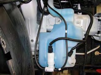 Reconnect the windshield washer reservoir, using all the existing hardware which was previously removed.