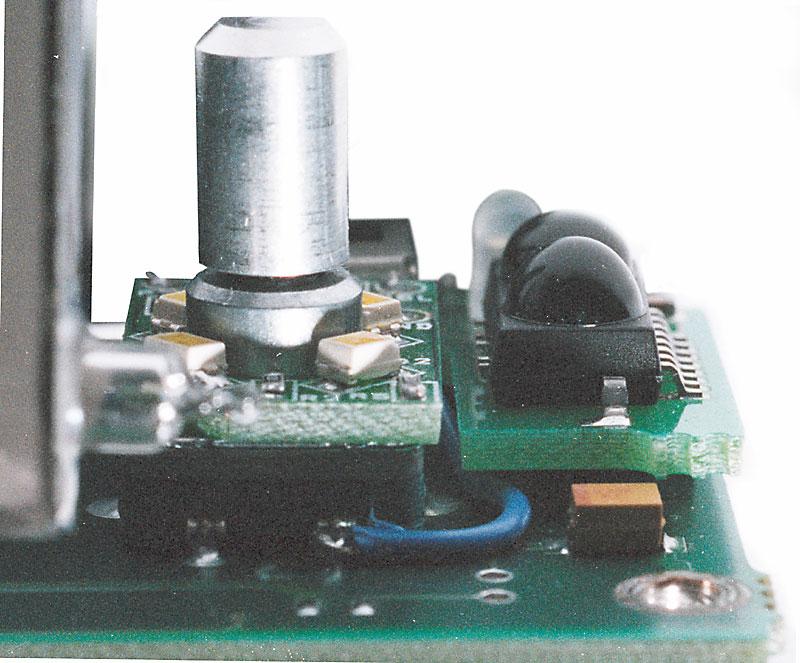 Make certain that the back of the board rests on the flat metal portion of the volume control rotary encoder.