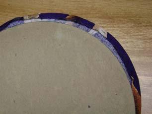 Remove cardboard. Applique the circles onto the 10 ½ squares of AS 24 Purple.
