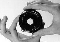 DEVELOPING TANK - Container that is light-proof, used for processing exposed film. An adjustable DIAPHRAGM in a lens controls the size of the aperture.
