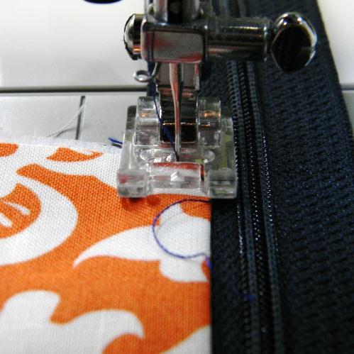 Using a zipper foot, or a straight presser foot, stitch the pieces together, using the zipper as a guide, with a ¼ in seam