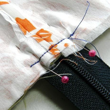 Next, using a ¼ in seam allowance, stitch through ALL layers across the width of the zipper,