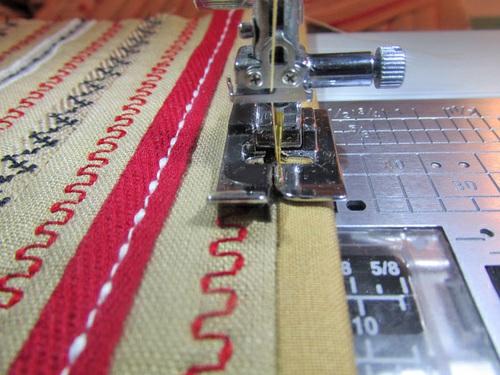 9. Trim any excess so the binding is flush with the raw edges of the layered pocket panel.