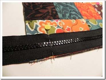 Lay the zipper down on top of the bag side and on the other end of the zipper, place a pin 1