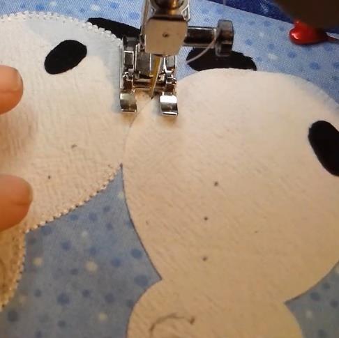 Buttonhole stitch going right back over those straight stitches and sew around the rest of the snowlady