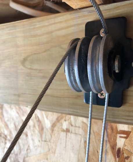 This cable will then loop over the first of the single pulleys (½ off center). 8.