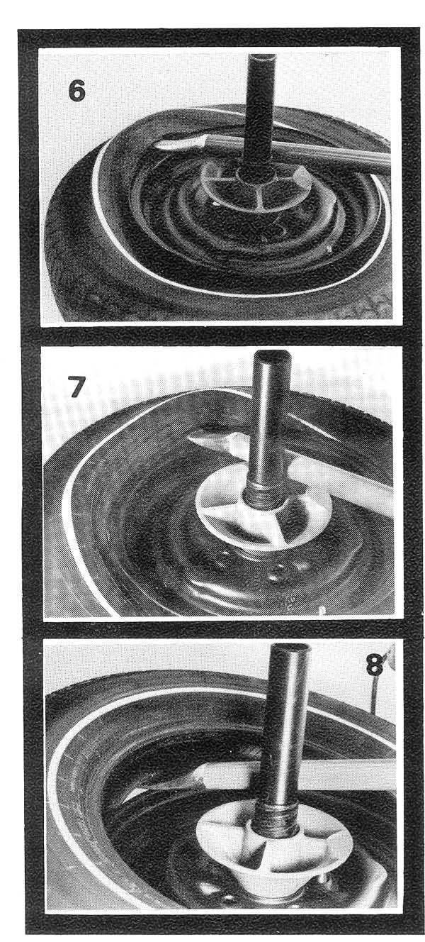 Push top bead down into drop center of the rim and reach across wheel and insert take-off end of the combination tool under top bead. Lower handle as shown in Fig. 6. 3.
