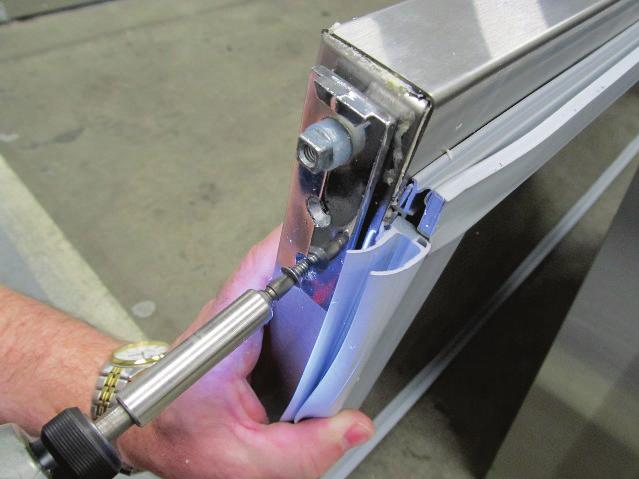 Once the insulation is removed, insert the self-closing hinge cartridge into the hole